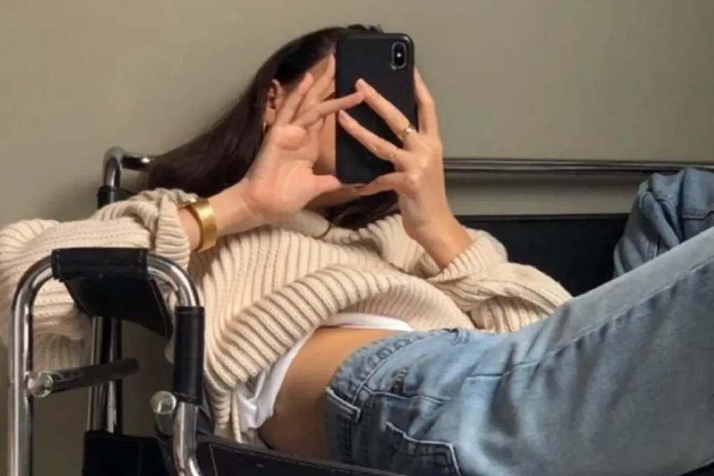 Jovem deitada no sofá mexendo no celular